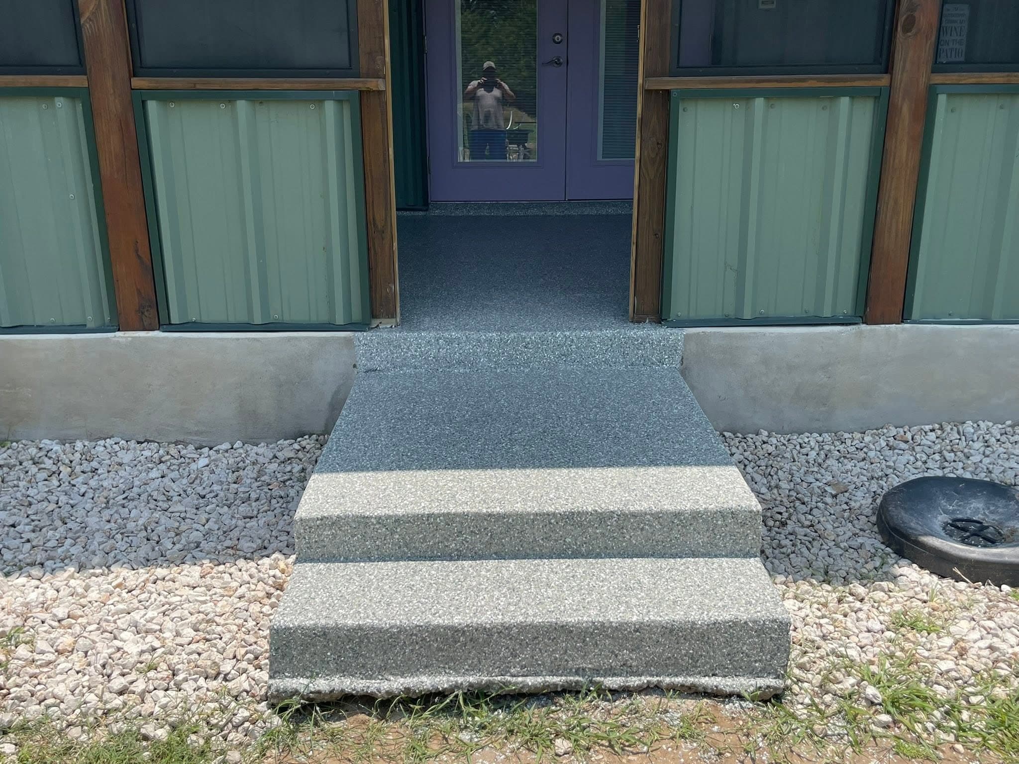 Coated steps and walkway leading into a screened patio