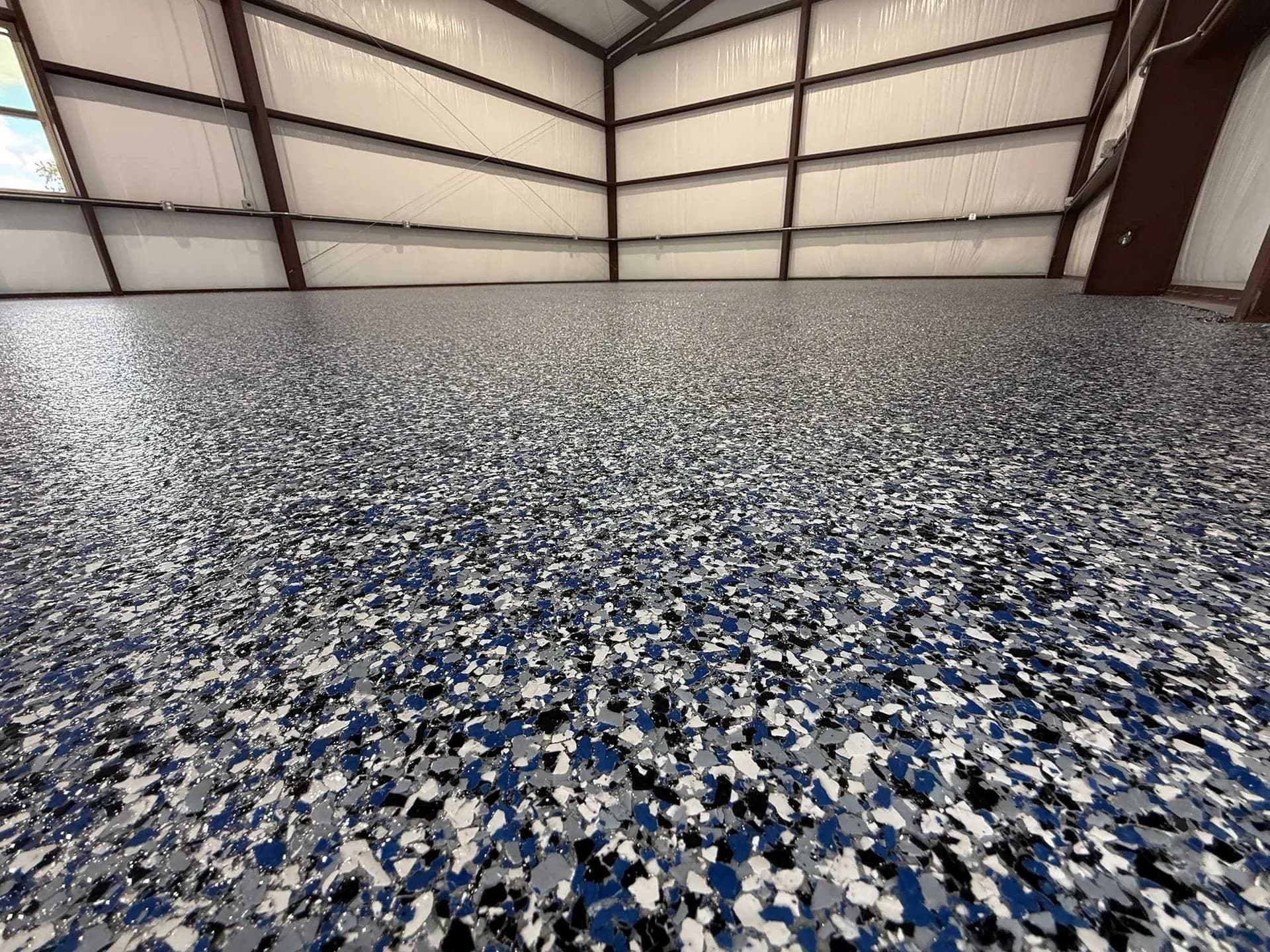 Metal shop building with a blue, black and white large-flake floor