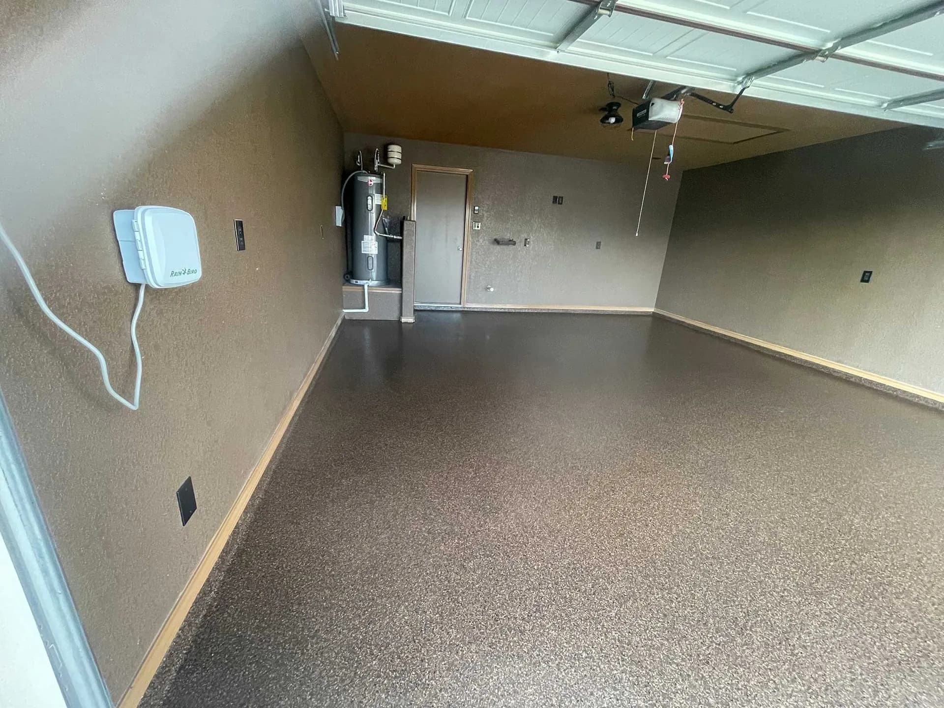 Two-car garage finished in a warm brown flake floor