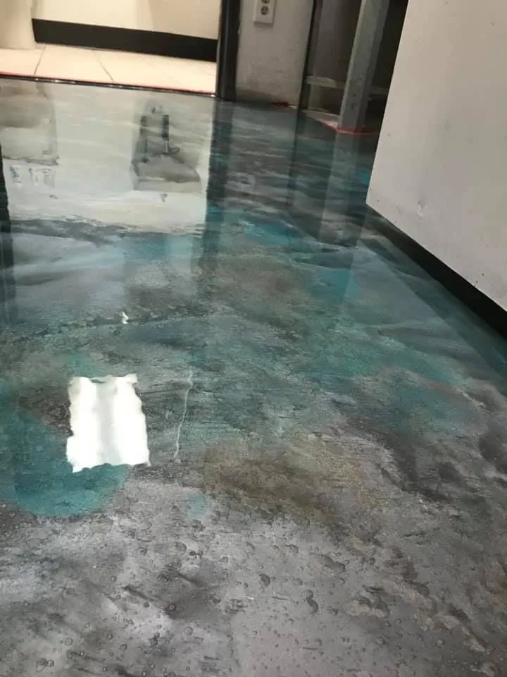 Teal blue-green metallic epoxy floor, close view