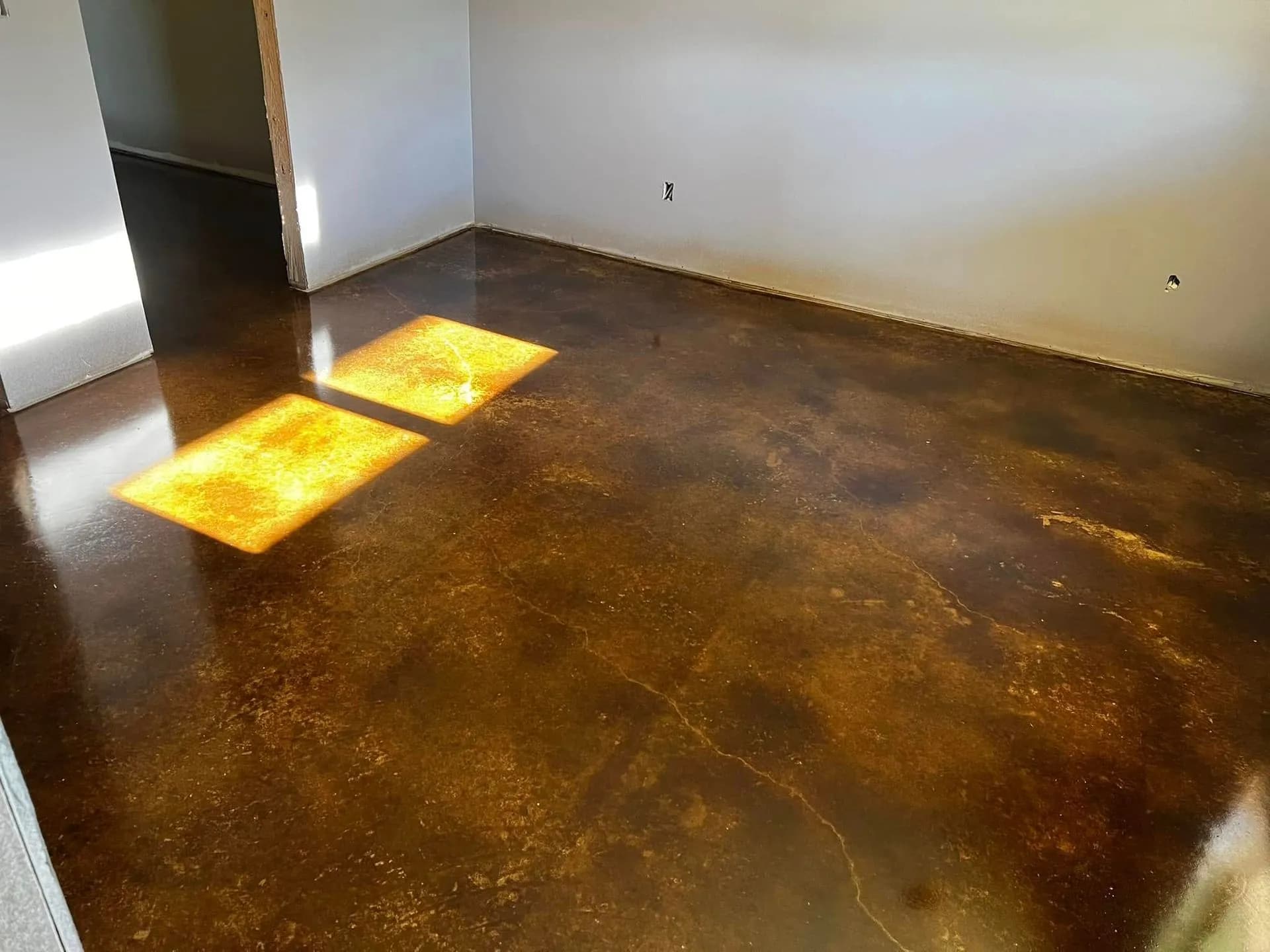 Amber stained concrete floor in a sunlit room