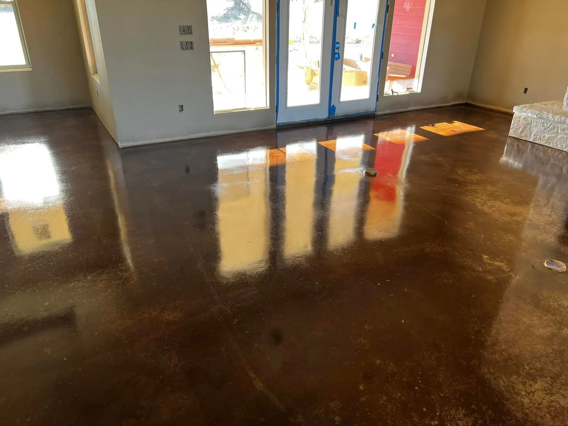 Dark brown stained concrete floor in a home under construction
