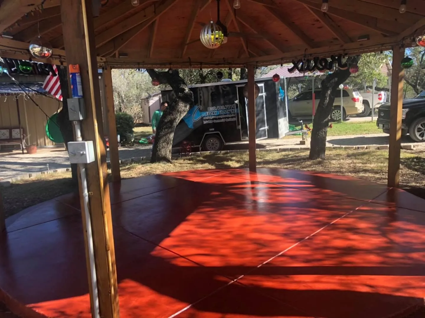 Maroon stained concrete floor in an outdoor gazebo pavilion