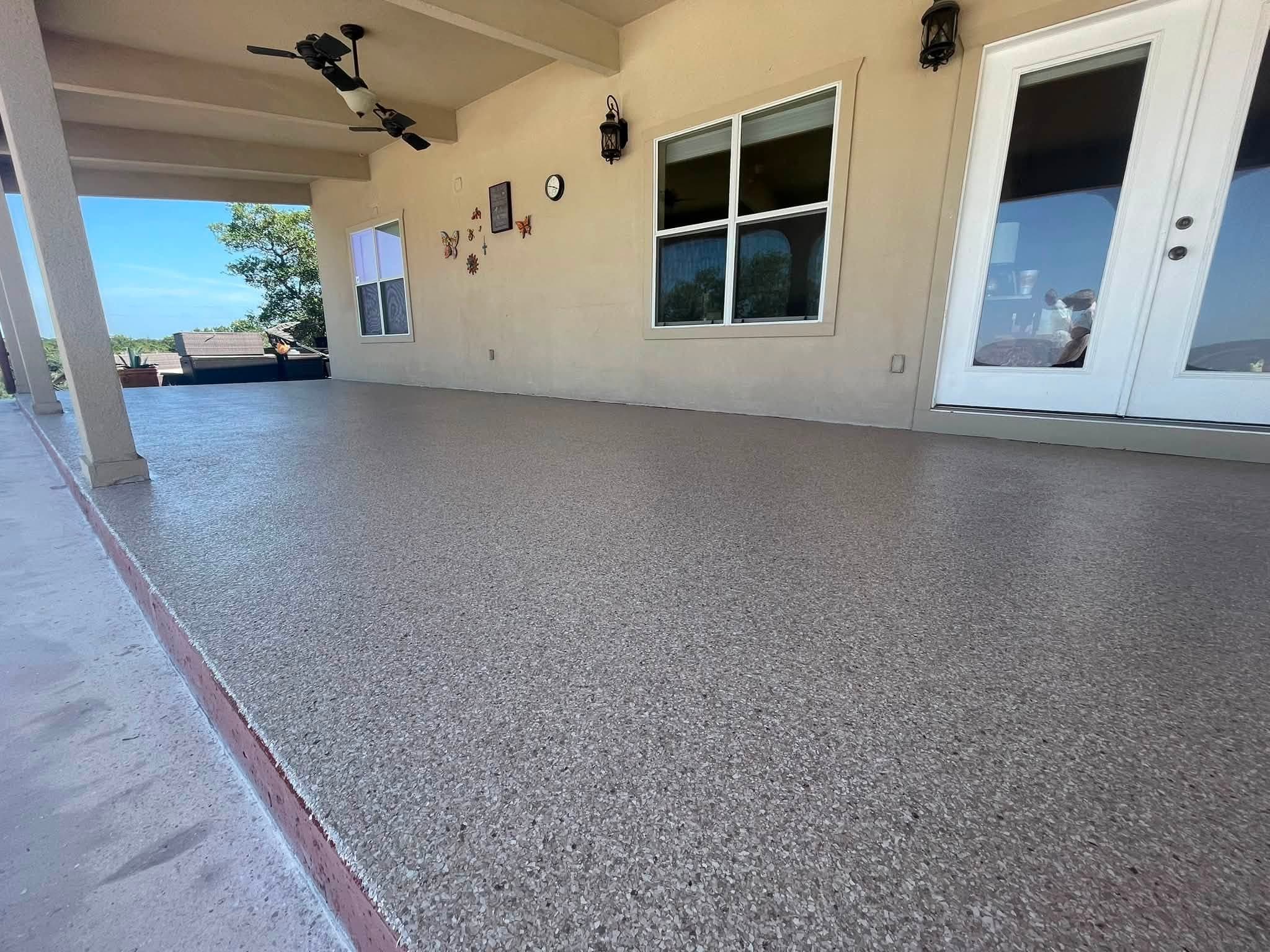Covered porch finished in a fine speckled coating, ceiling fan above